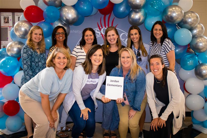 A group of teachers smile